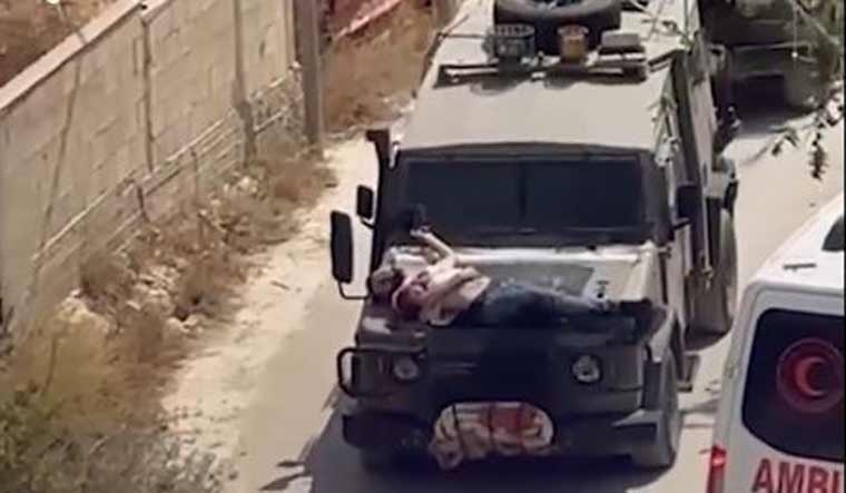 Israeli Soldiers Tie Injured Palestinian to Jeep in West Bank, Video Goes Viral